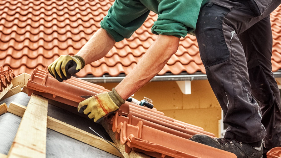 man installing tile roof in a house tempe az